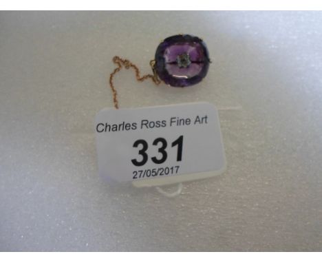 A late Victorian amethyst and diamond brooch, the cushion shaped amethyst with concave centre supporting a claw mounted old c