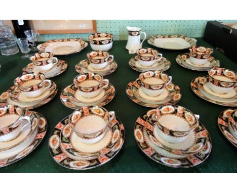 An Edwardian Shore & Coggins part-tea service, comprising: twelve trios, two square dishes, milk jug and open sugar bowl.