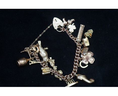 9ct Gold charm bracelet, 17 charms Weight 44.5g with heart shaped lock &amp; safety chain 