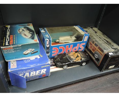 A shelf of mixed die-casts and plastic vehicles including Maisto, Realtoy, radio controlled Porsche 928 etc