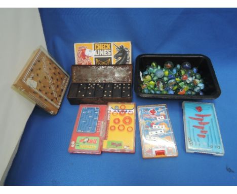 A selection of vintage pocket games including Triang Checklines, Dominoes and marbles