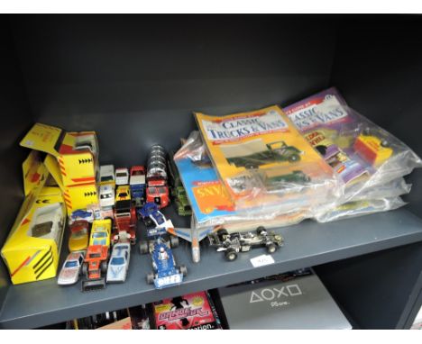 A shelf of mixed die-casts including Days Gone magazines, Corgi, Shell etc