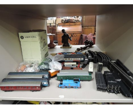 A shelf of OO gauge rolling stock, accessories and track etc including Hornby, Britains etc