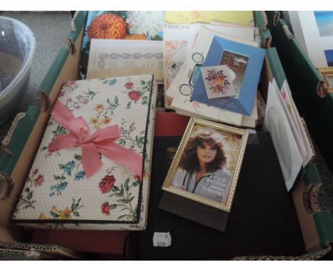 A box of ephemera including vintage cards and photographs