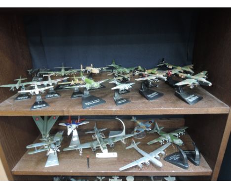 Two shelves of twenty two modern die-cast aircrafts including, Corgi Aviation Archive Series and similar