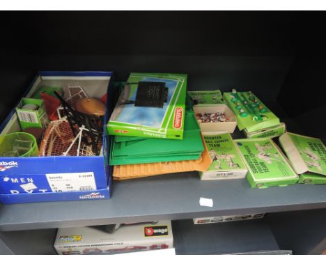 A shelf of vintage Subbuteo accessories including Express Teams, Interchangeable Goalkeepers, score board etc some with boxes