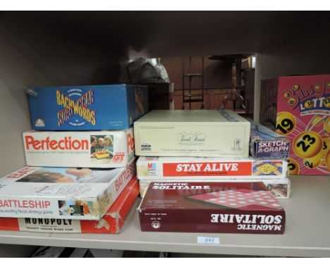 A shelf of vintage games including Perfection, Stay Alive and Battleships etc