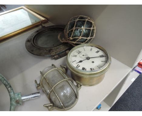A brass port hole, brass ships clock, brass light and a fisherman's glass float