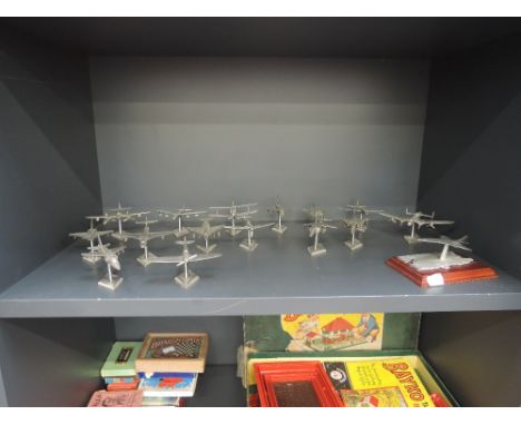 A shelf of sixteen English miniatures and similar modern pewter airplanes