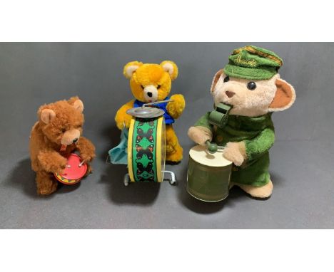 A Carl original wind up bear with drum along with a vintage battery operated drumming bear and a Harrods battery operated dru