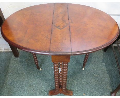 A Victorian burr walnut Sutherland table with bobbin turned legs and white china castors, 78cm x 60cm x 60cm