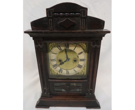 An Edwardian 30 hour striking pendulum mantle clock with an enamel Roman chapter on a brass back plate with brass spandrels w