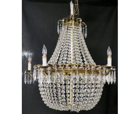 An empire style chandelier electric ceiling light fitting, gilt brass with swags of graduated beads in two tiers, eight light