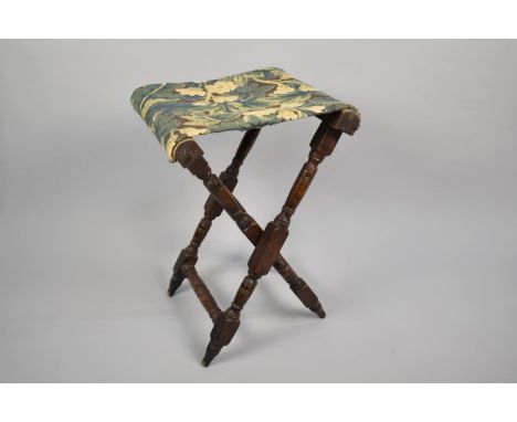 A 19th Century Folding Campaign Stool with a Tapestry Seat, 57cms High 