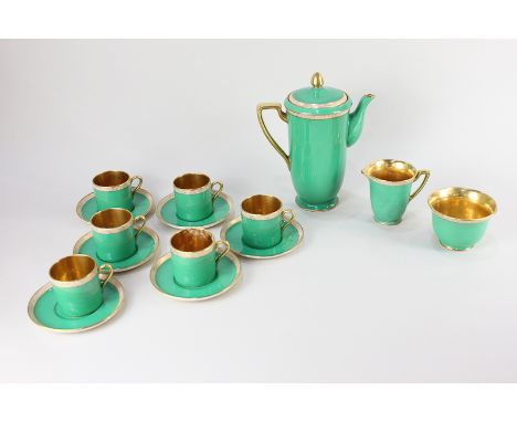 A Crown Devon porcelain green and gilt coffee set, comprising coffee pot, milk jug, sugar bowl, and six cups and saucers 