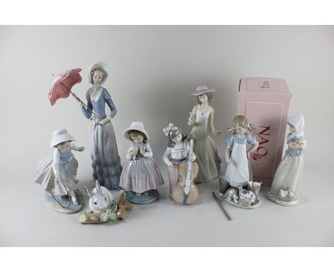 Three Lladro porcelain figures, a woman with a parasol, a girl with a mop and three cats and a rabbit, together with five Nao