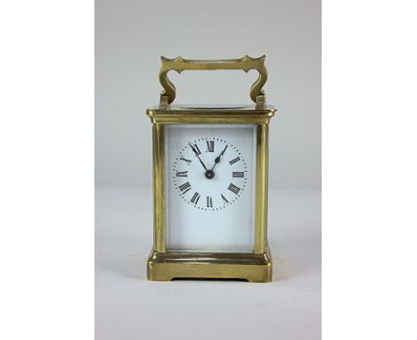 A gilt brass and bevelled glass cased carriage clock, the rectangular white dial with Roman numerals 15cm high