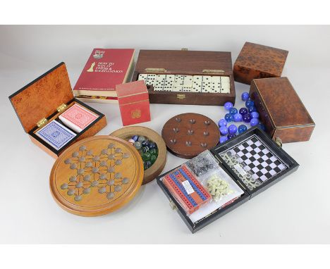 A Dominoes set within box with cribbage lid, a solitaire board with marbles, a travelling games set, boxed playing cards, a J