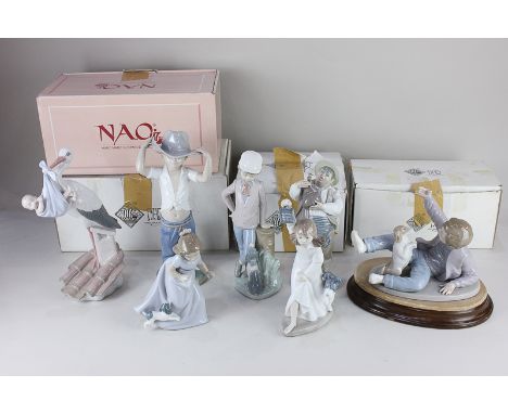 Two Lladro porcelain figures, a man with a water skin and a stork carrying a baby (a/f) and five Nao porcelain figures, inclu