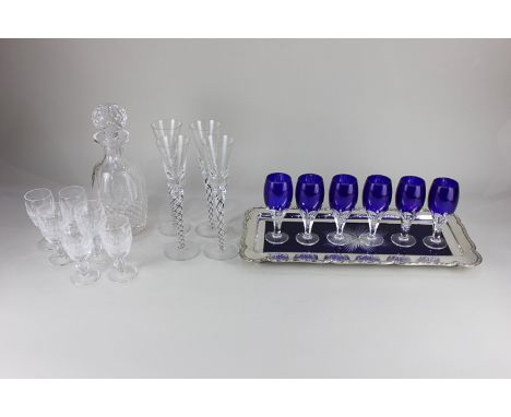 A Waterford glass decanter and set of six sherry glasses, together with a set of four glass wine flutes, each with double whi