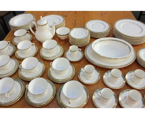 A Royal Doulton porcelain 'Clarendon' pattern part dinner, tea and coffee service, decorated with green and gilt borders on w