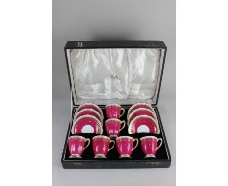 A Spode 'Ryde' pattern set of six bone china coffee cups and saucers, in maroon and white, with gilt embellishments, in fitte