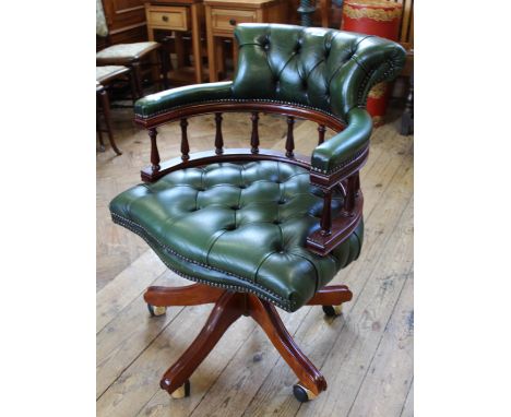 A modern green leather button back office chair