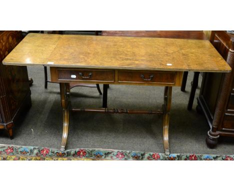 A reproduction burr walnut sofa table raised on lyre supports 