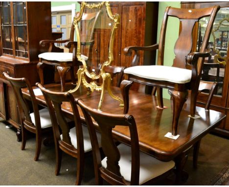 A reproduction mahogany extending dining table in the William IV style together with a matching set of eight dining chairs in