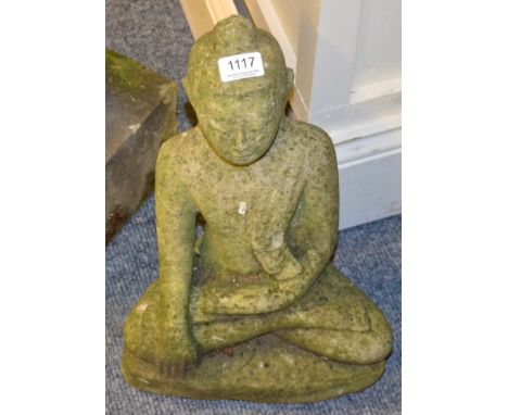 Weathered stone garden statue in the form of a seated Buddha 