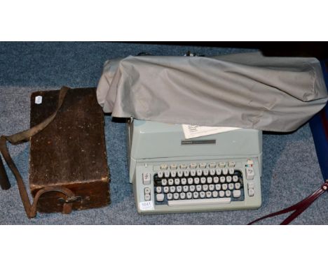 A Hermes ambassador electric typewriter with instruction booklet and original invoice; together with a theodolite and tripod 