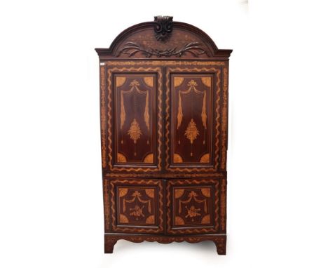 A 19th Century Dutch Mahogany and Marquetry Inlaid Free-Standing Corner Cupboard, the moulded top centred by a scrolled and a