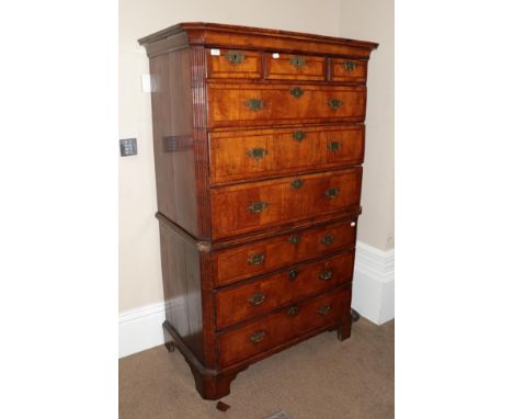 A George II Walnut, Crossbanded and Featherbanded Chest on Chest, 2nd quarter 18th century, the moulded top above three short