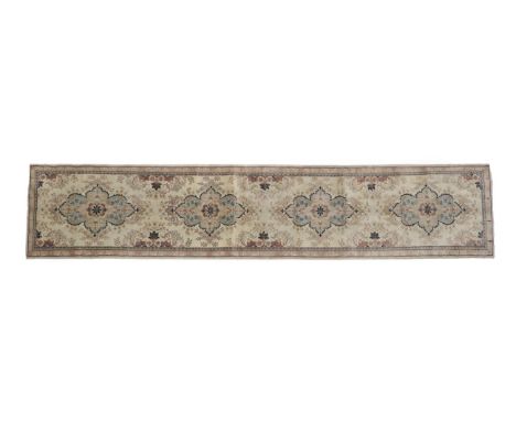 Narrow Kashan Runner Central Iran, 2nd half 20th century The ivory field with four flowerhead medallions enclosed by narrow b