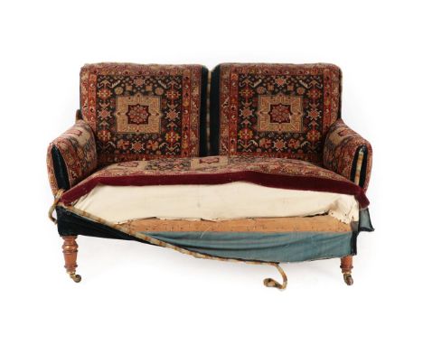 A Late Victorian Two-Seater Sofa, covered in geometric carpet, on walnut turned forelegs with brass castors, 132cm by 70cm by