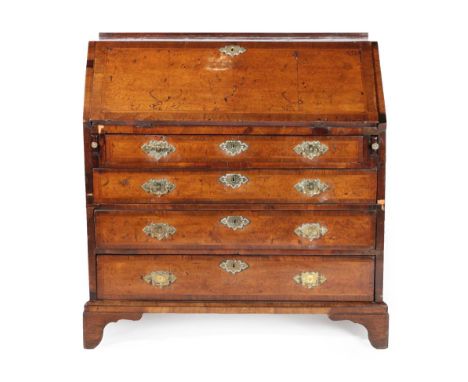 A George II Walnut, Burr Walnut and Featherbanded Bureau, 2nd quarter 18th century, the crossbanded top above a fall front en