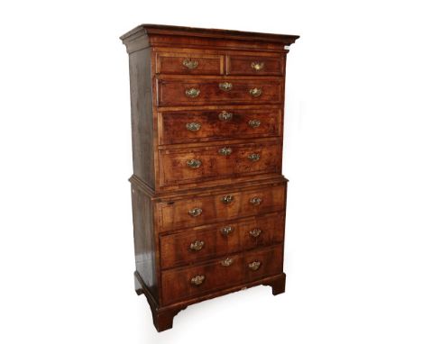 A George II Walnut Chest on Chest, Mid 18th century, the moulded cornice above a strung frieze and two short over three long 