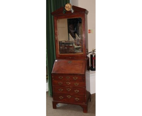 A George III Mahogany Bureau Bookcase, late 18th century, the upper section with architectural pediment surmounted by a gilde