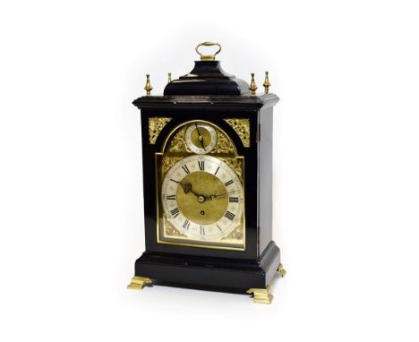 An 18th Century Style Ebonised Table Timepiece, early 20th century, inverted bell top pediment with carrying handle, bracket 