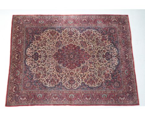 Fine Kashan Carpet Central Iran, circa 1930 The ivory field of flowering plants and vines centred by a raspberry medallion, t