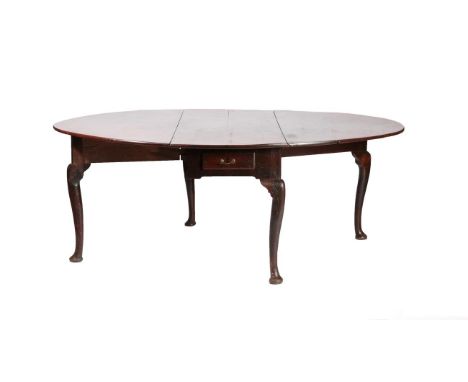 A Ten to Twelve Seater Oak Gateleg Dining Table, 2nd quarter 18th century, with two rounded drop leaves to form and oval abov