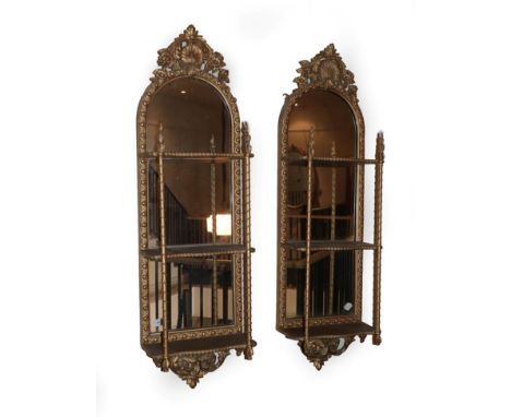 A Pair of Victorian Gilt and Gesso Wall Shelves, circa 1870, of three tier form, the original mirror plates within guilloche 