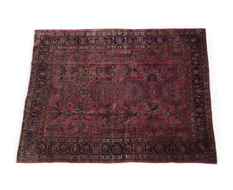 Saroukh Carpet West Iran, circa 1930 The brick red field of semi naturalistic plants and flowers enclosed by midnight blue bo