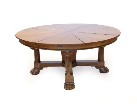 A 20th Century Jupe Style Extending Dining Table by Maple &amp; Co, with eight additional leaves to make a circle, on stop-fl