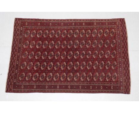 Tekke Main Carpet Emirate of Bukhara, circa 1900 The brick red field with five columns of quartered guls enclosed by borders 