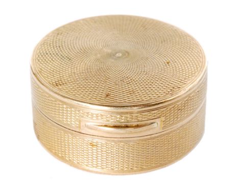 A George V hallmarked 9ct circular pill box by Asprey and Co, with engine turned decoration and hinged cover, diameter 3.5cm,
