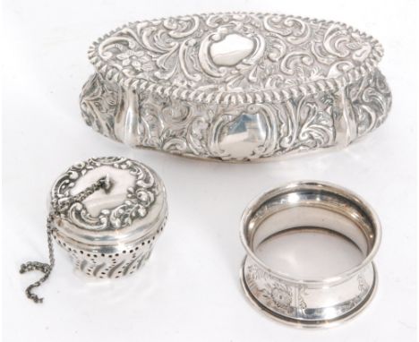 A hallmarked silver oval trinket box with embossed foliate decoration to whole, length 11cm, Birmingham 1900, with a napkin r