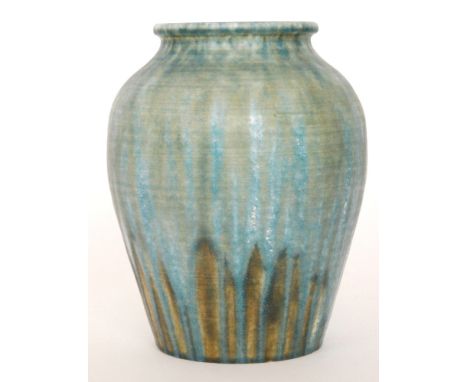 A large Ruskin Pottery vase of bulbous form decorated in a streaked tonal blue glaze with patches of lighter blue crystalline