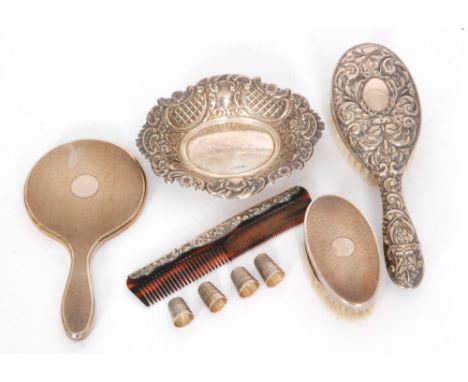 A small parcel lot of hallmarked silver items to include an oval C scroll embossed pin dish, a silver backed brush, an associ