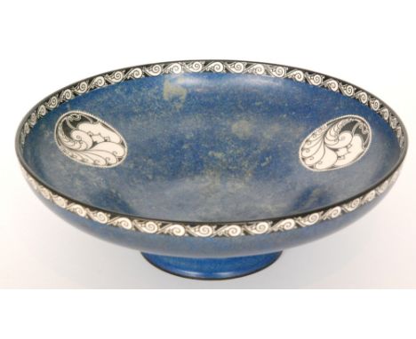 A 1920s Royal Worcester Crown Works footed bowl decorated in a mottled blue green with black and white Art Deco style roundel